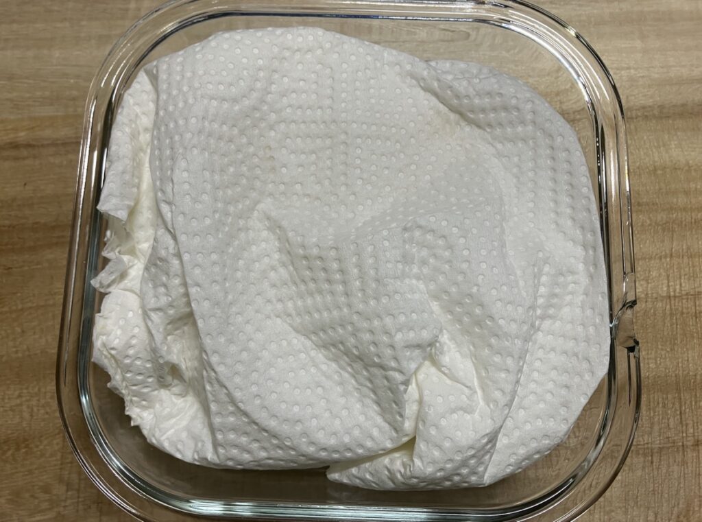 キッチンペーパーで包んで耐熱容器に入れた絹ごし豆腐の画像